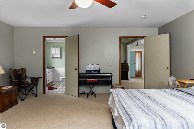 bedroom with connected bathroom, a ceiling fan, and carpet