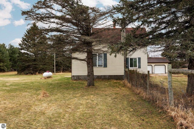 view of home's exterior featuring a garage and a yard