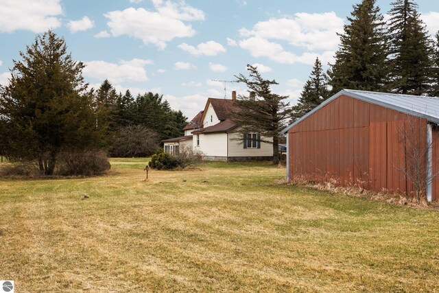view of yard featuring an outbuilding and an outdoor structure
