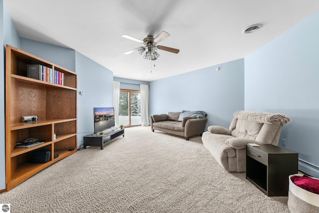 800 Evart St, Cadillac, MI 49601 - living room with visible vents, a baseboard radiator, carpet, and ceiling fan