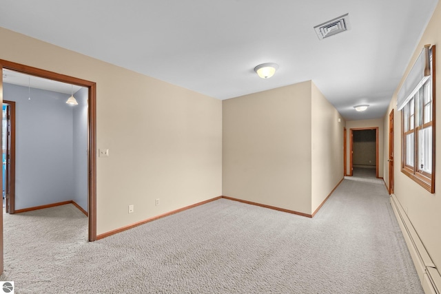 800 Evart St, Cadillac, MI 49601 - carpeted spare room featuring baseboards, a baseboard heating unit, and visible vents