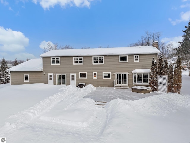 800 Evart St, Cadillac, MI 49601 - snow covered house featuring a chimney