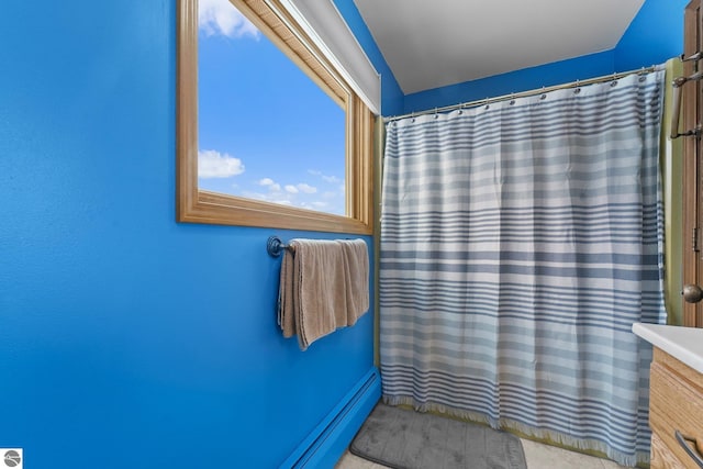 800 Evart St, Cadillac, MI 49601 - bathroom with a baseboard radiator, a shower with shower curtain, and vanity