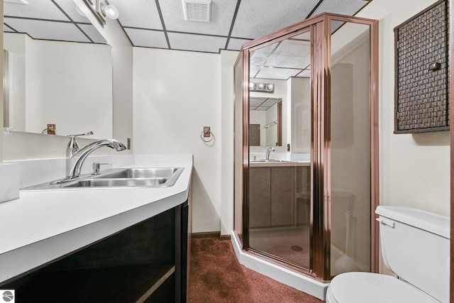 800 Evart St, Cadillac, MI 49601 - bathroom featuring visible vents, toilet, baseboards, a paneled ceiling, and a shower stall