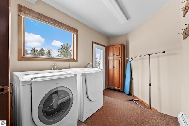 800 Evart St, Cadillac, MI 49601 - washroom with separate washer and dryer, a baseboard heating unit, cabinet space, and light colored carpet
