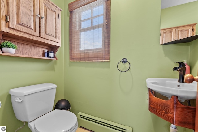 800 Evart St, Cadillac, MI 49601 - bathroom featuring a baseboard radiator and toilet