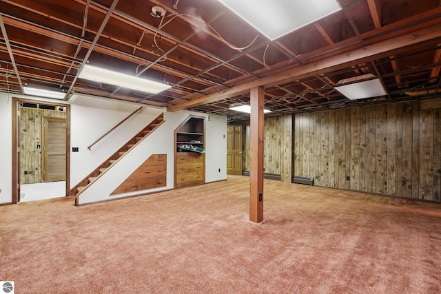 800 Evart St, Cadillac, MI 49601 - finished basement with carpet flooring, wood walls, and stairway