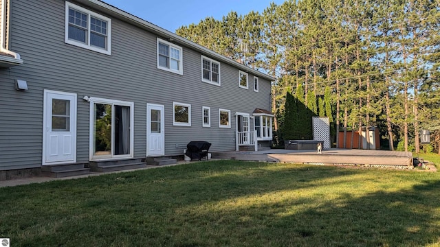 800 Evart St, Cadillac, MI 49601 - rear view of property featuring a wooden deck, a yard, and entry steps