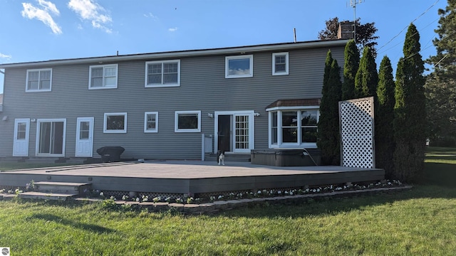 800 Evart St, Cadillac, MI 49601 - back of property with a chimney, a lawn, a covered hot tub, and a deck