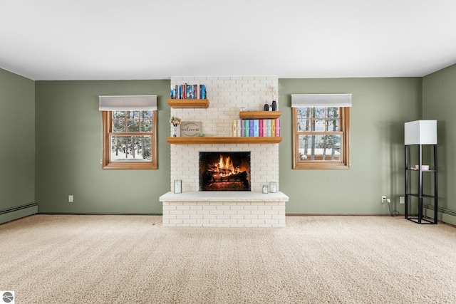 800 Evart St, Cadillac, MI 49601 - unfurnished living room featuring carpet floors, a brick fireplace, and a healthy amount of sunlight