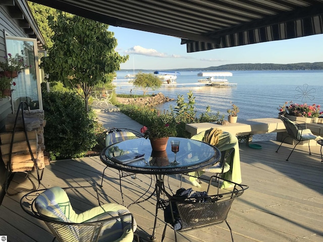 1137 Crystal Dr, Frankfort, MI 49635 - deck with outdoor dining area and a water view