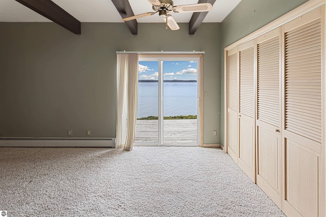 1137 Crystal Dr, Frankfort, MI 49635 - unfurnished bedroom with carpet flooring, beam ceiling, a water view, access to exterior, and baseboard heating