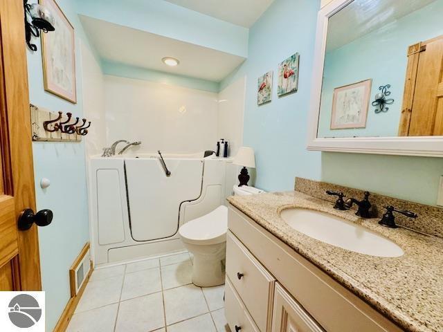 102 James Sq, Roscommon, MI 48653 - bathroom featuring tile patterned flooring, a bath, vanity, and toilet