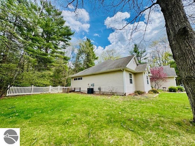 102 James Sq, Roscommon, MI 48653 - view of side of home featuring cooling unit