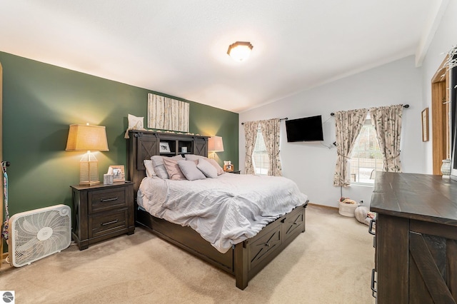 bedroom featuring light colored carpet and lofted ceiling