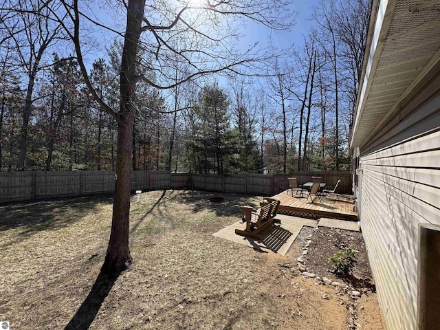 view of yard with a fenced backyard and a deck