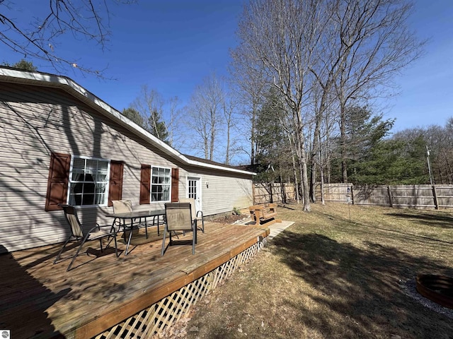 wooden terrace with outdoor dining space and fence