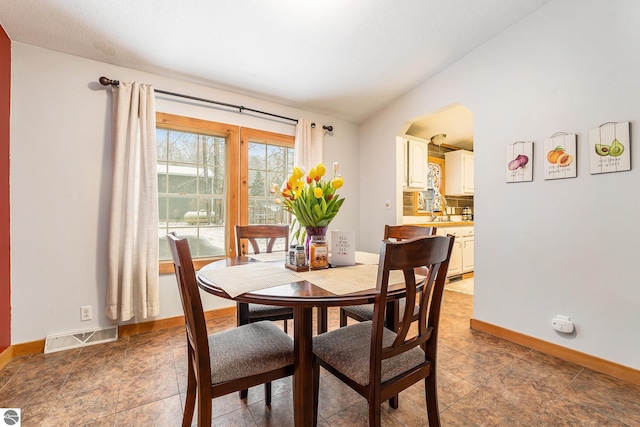dining room with baseboards and visible vents