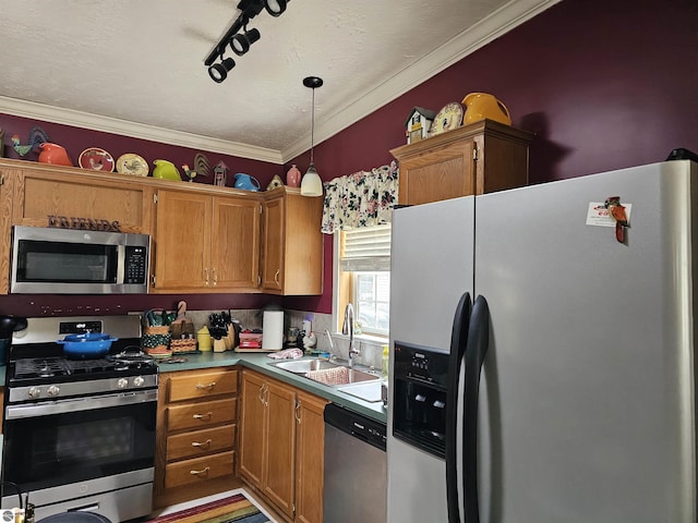 kitchen with decorative light fixtures, a sink, ornamental molding, brown cabinetry, and stainless steel appliances