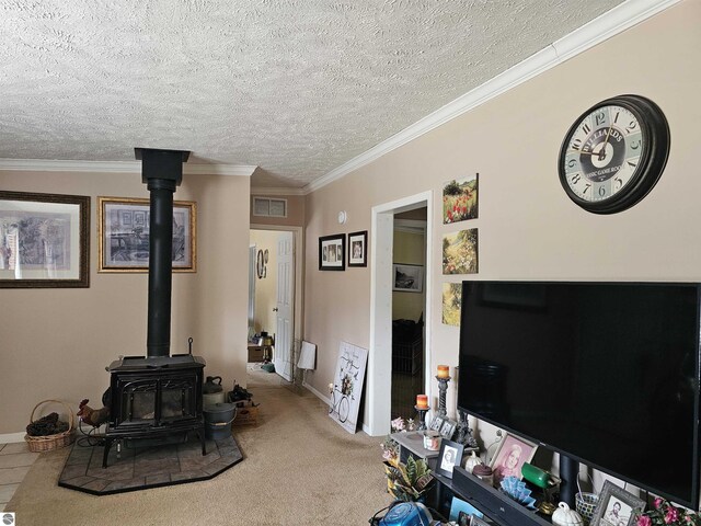 carpeted living room featuring a wood stove, visible vents, a textured ceiling, and baseboards