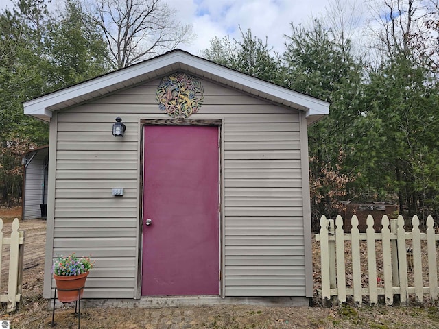 view of shed with fence