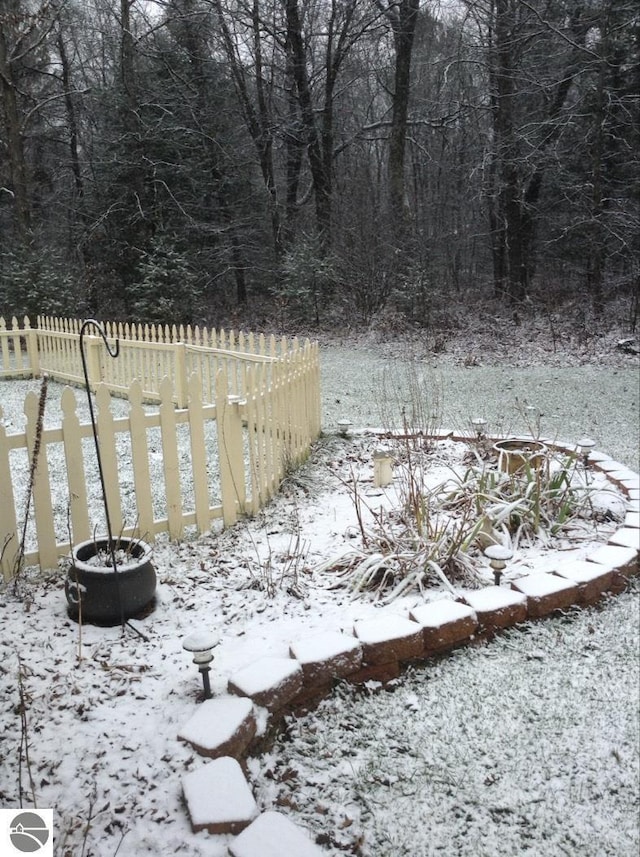 yard layered in snow with fence