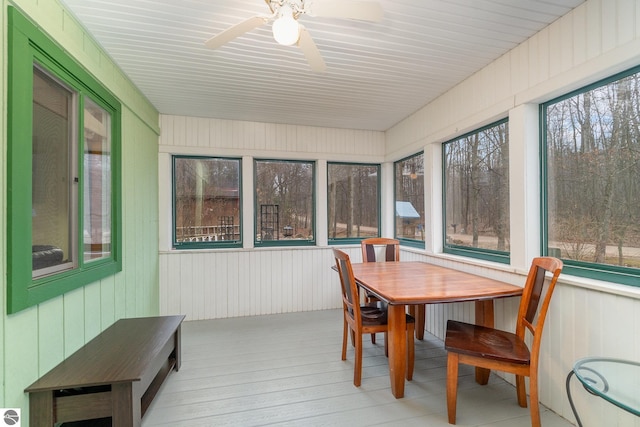 sunroom / solarium featuring a wooden deck and wood finished floors