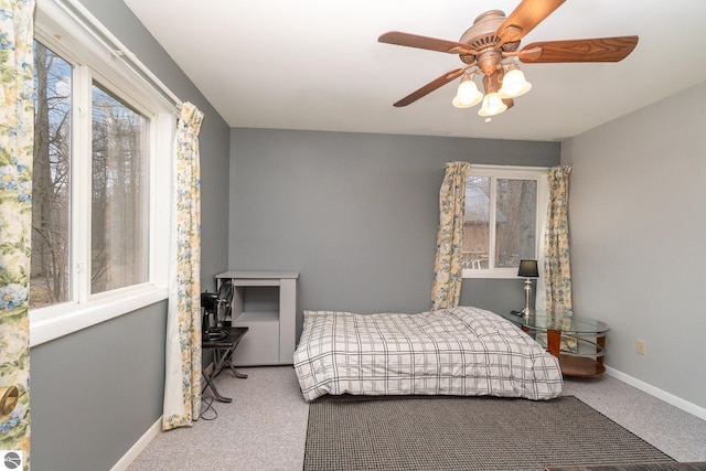 bedroom with baseboards, carpet floors, and ceiling fan