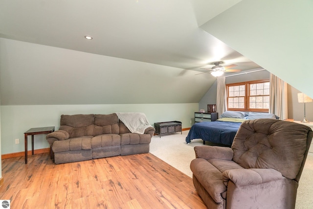 bedroom featuring ceiling fan, baseboards, vaulted ceiling, and light wood-type flooring