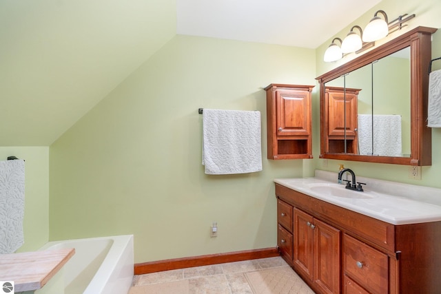 full bath with a bathing tub, vanity, and baseboards