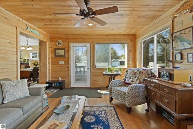 112 N Benzie Blvd, Beulah, MI 49617 - living area with ceiling fan, wood walls, wood ceiling, and wood-type flooring