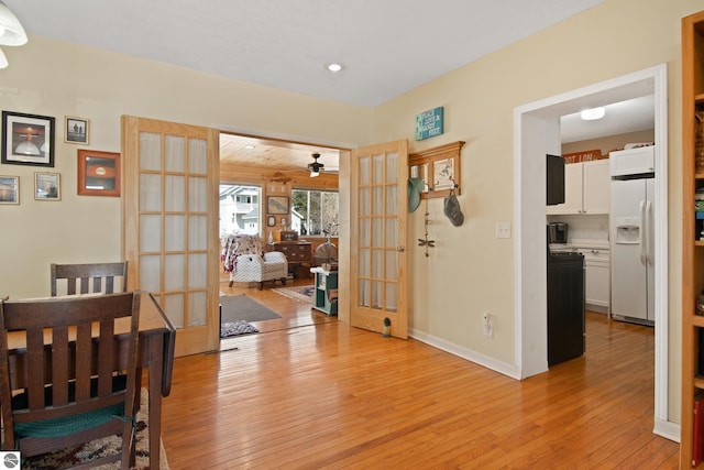 112 N Benzie Blvd, Beulah, MI 49617 - dining area with french doors, light wood-style flooring, and ceiling fan