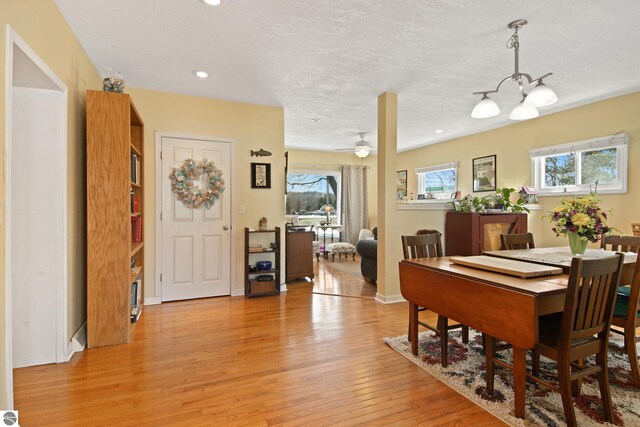 112 N Benzie Blvd, Beulah, MI 49617 - dining room featuring plenty of natural light, baseboards, light wood-style flooring, and recessed lighting