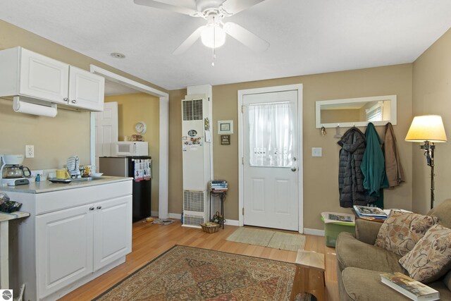 112 N Benzie Blvd, Beulah, MI 49617 - interior space featuring baseboards, ceiling fan, and light wood-type flooring