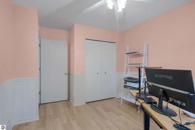 office featuring wood finished floors, ceiling fan, and wainscoting