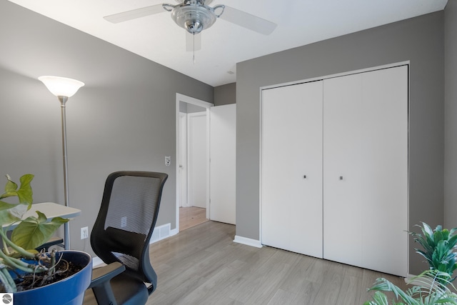 office with baseboards, light wood-style flooring, and ceiling fan