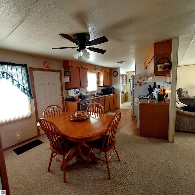 4548 Goldenrod Dr, Traverse City, MI 49686 - dining space with a ceiling fan and a textured ceiling