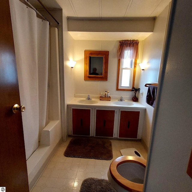 4548 Goldenrod Dr, Traverse City, MI 49686 - bathroom with curtained shower, double vanity, toilet, and tile patterned floors