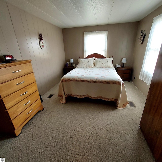 4548 Goldenrod Dr, Traverse City, MI 49686 - bedroom with multiple windows and carpet