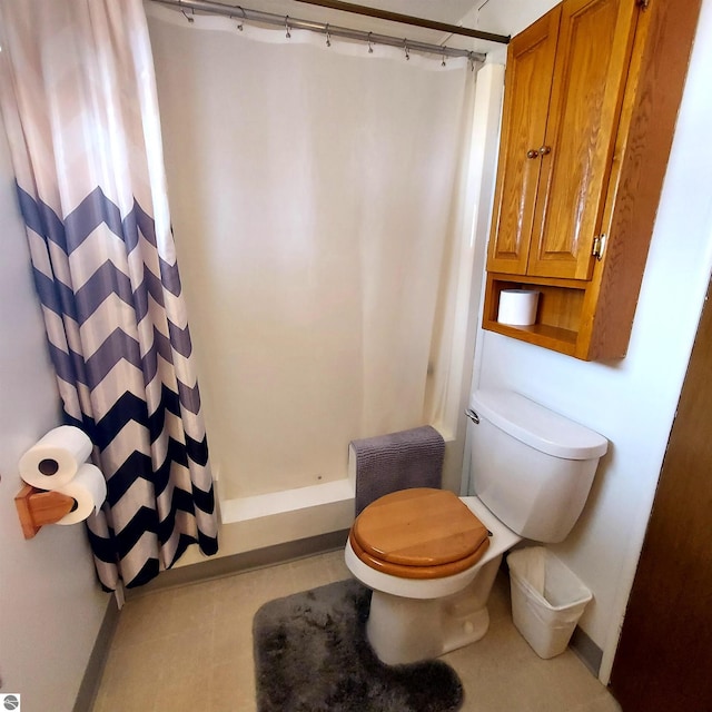 4548 Goldenrod Dr, Traverse City, MI 49686 - full bathroom with curtained shower, baseboards, and toilet
