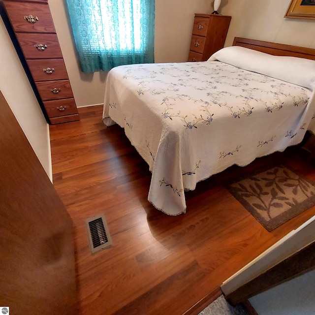 4548 Goldenrod Dr, Traverse City, MI 49686 - bedroom with dark wood finished floors