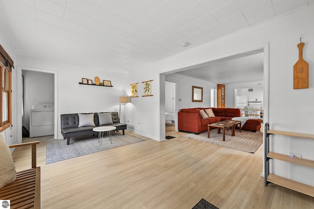living room featuring wood finished floors and washer / clothes dryer