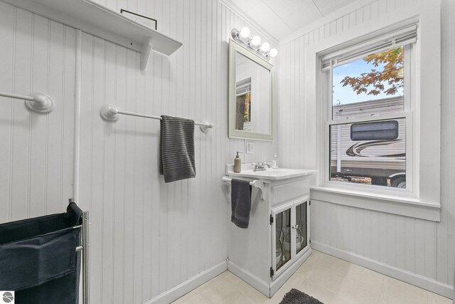 bathroom with a sink and baseboards