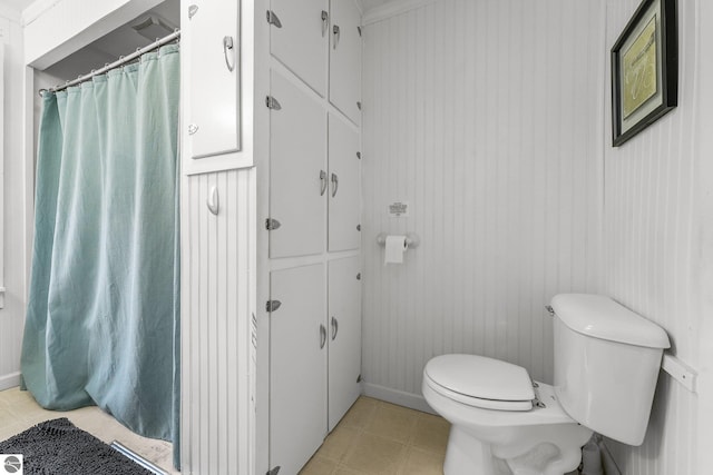 full bathroom featuring toilet and tile patterned flooring