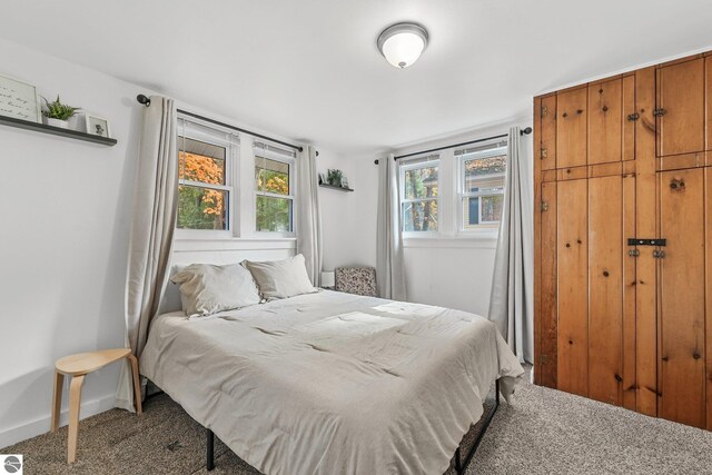 carpeted bedroom featuring baseboards