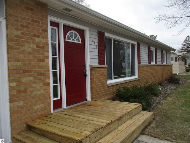 property entrance with brick siding
