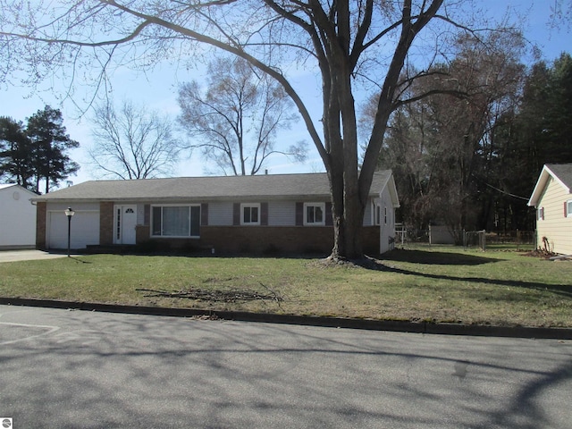 single story home with a garage, driveway, and a front lawn