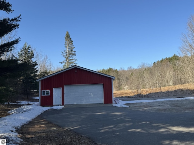 detached garage with a wooded view