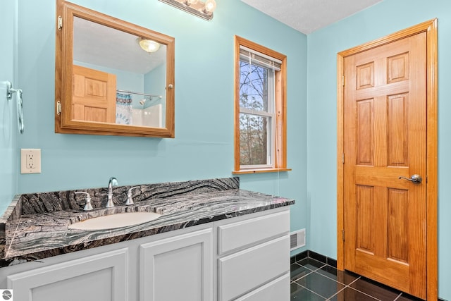 full bath featuring visible vents, baseboards, curtained shower, vanity, and tile patterned floors