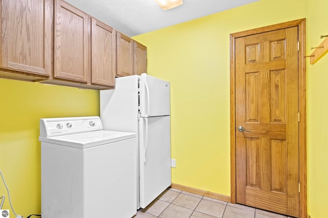 laundry room with washer / clothes dryer, light tile patterned floors, baseboards, and cabinet space